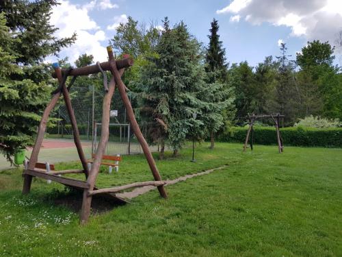 a park with a swing set and a playground at Penzion Skalka in Skalka
