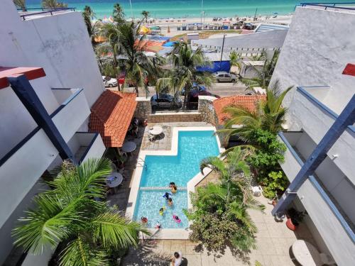 an overhead view of a pool at a resort with a beach at Progreso Beach Hotel in Progreso