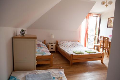 a bedroom with two beds and a window at Gościniec Mazurski in Ruciane-Nida