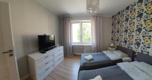 Łóżko lub łóżka w pokoju w obiekcie Apartament Blisko Morza Gdynia