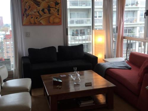 a living room with a couch and a coffee table at Lo de Mario al rio in Buenos Aires