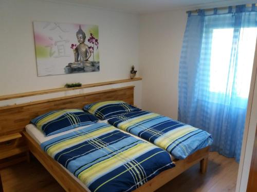 a bedroom with two beds with blue and yellow pillows at Ferienhaus Mochorko in Sittersdorf
