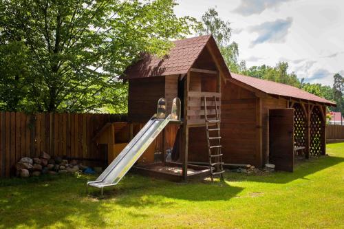 a play house with a slide in front of it at Gościniec Mazurski in Ruciane-Nida