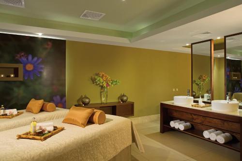 a bathroom with two beds and a sink at Secrets Royal Beach Punta Cana - Adults Only - All Inclusive in Punta Cana