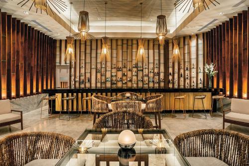 a restaurant with chairs and tables and a bar at Secrets Royal Beach Punta Cana - Adults Only - All Inclusive in Punta Cana