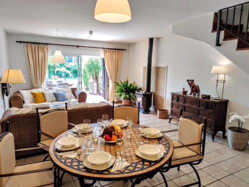 a living room with a table and chairs at Spacious Beachfront Town House in Estepona with Fully Equipped Kitchen, Pools, Garden, Sea View in Estepona