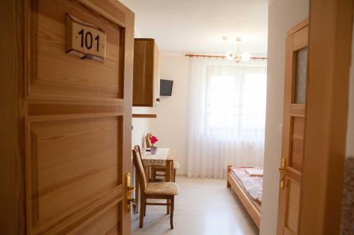 a door leading into a room with a bedroom at Gościniec Mazurski in Ruciane-Nida