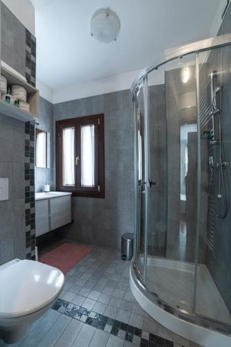 a bathroom with a shower and a toilet and a sink at Ca' degli Specchieri in Venice