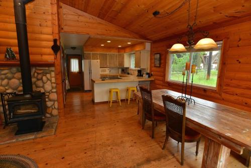 a kitchen and dining room of a log cabin at The Park Chalet by Casago McCall - Donerightmanagement in McCall
