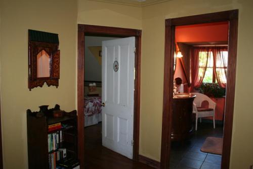 a living room with a door and a room with a table at Gîte À l'Augustine in Quebec City
