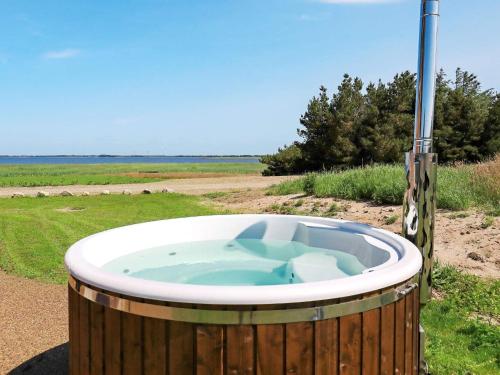 a jacuzzi tub in the middle of a field at 20 person holiday home in Ulfborg in Husby