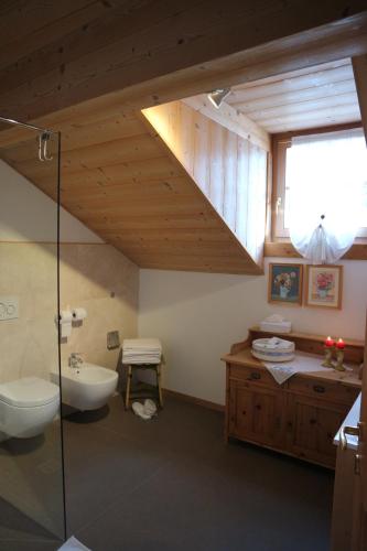 a bathroom with a sink and a toilet and a sink at B&B Casa Riz in Castello di Fiemme