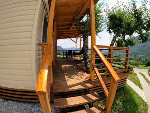 a porch of a house with a wooden deck at Apartments Denis in Tolmin