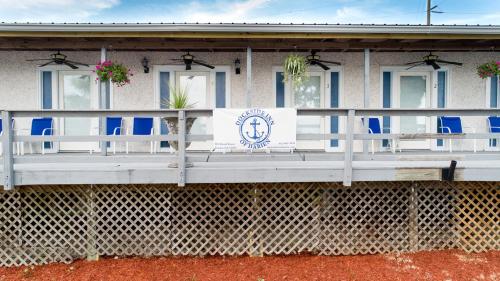 a building with a porch with blue and white chairs at Darien Dockside Inn in Darien