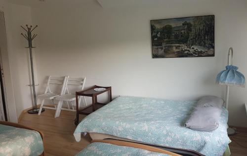 a bedroom with a bed and a table and chairs at GRAŽINOS SODYBA in Telšiai
