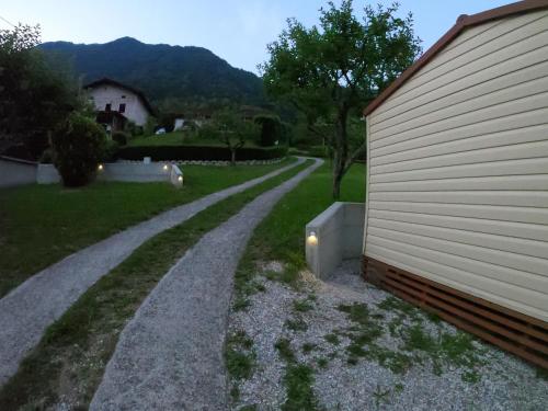 a gravel road next to a house next to a building at Apartments Denis in Tolmin