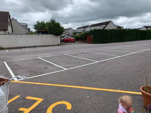 a child standing in a parking lot at The Carisbrooke in Forres