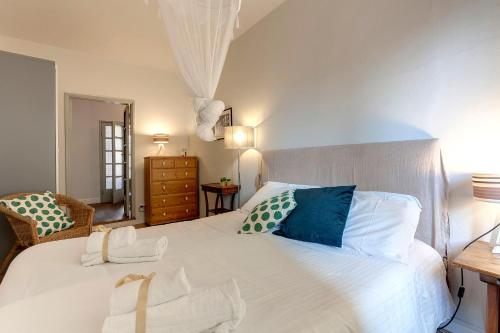 una camera da letto con un grande letto bianco con cuscini blu di Mamo Florence - Nori Apartment a Firenze