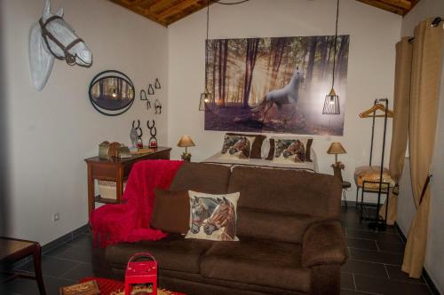 a living room with a couch and a picture of a wolf at Quinta do Malhinha- Turismo in Angra do Heroísmo