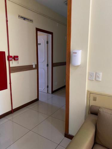 a living room with a couch and a door at Palácio Do Rio Hotel in Teresina