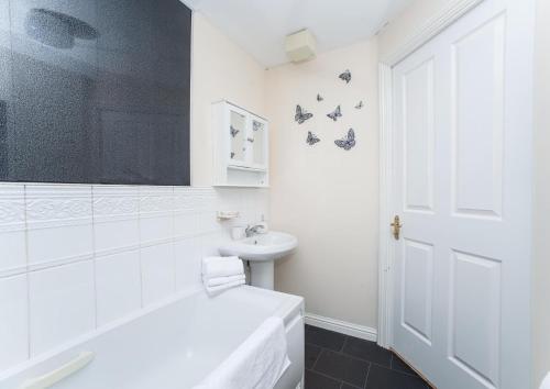 a white bathroom with a toilet and a sink at Sea Winnings Apartment South Shields in South Shields