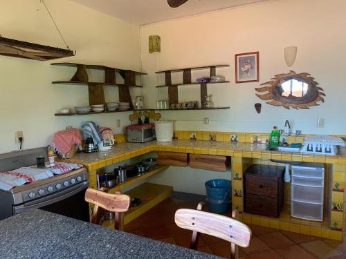 a large kitchen with a counter and a counter top at Hotel Casamar Suites in Puerto Escondido