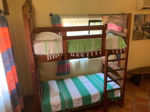 a couple of bunk beds in a room at Hotel Casamar Suites in Puerto Escondido