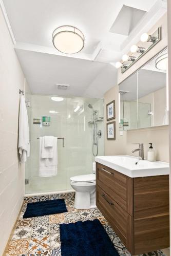 a bathroom with a sink and a toilet and a shower at North End Cottage in Boise