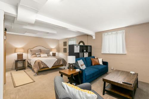 a living room with a bed and a blue couch at North End Cottage in Boise