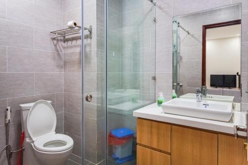 a bathroom with a toilet and a sink and a shower at GEM Apartment in Ho Chi Minh City