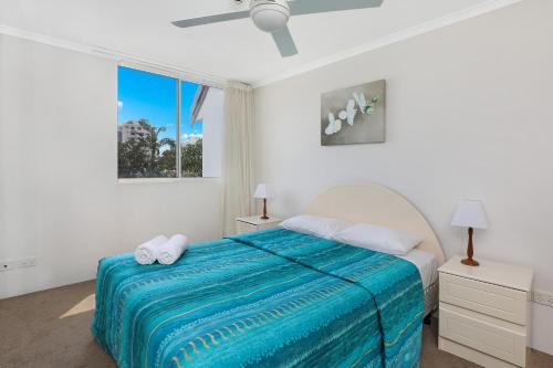 a white bedroom with a bed and a window at The Bay Apartments Coolangatta in Gold Coast