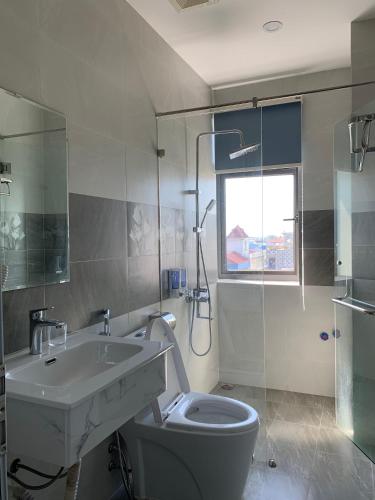a bathroom with a sink and a toilet at Win Win Hotel - Khách Sạn Hải Phòng in Hai Phong