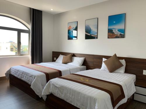 En eller flere senge i et værelse på Win Win Hotel - Khách Sạn Hải Phòng