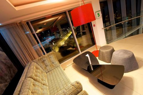 a living room with a couch and chairs and a large window at Holiday Inn Southend by IHG in Southend-on-Sea