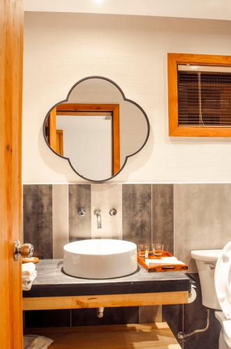 a bathroom with a sink and a mirror at Villa EN Emerald Valley, Huangshan in Huangshan Scenic Area