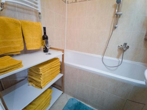 een badkamer met een bad, een douche en handdoeken bij FLEXIHOME sk - Vodna - city centre - with AC in Košice
