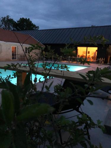 a swimming pool in front of a house at Hotell Persnäs in Persnäs