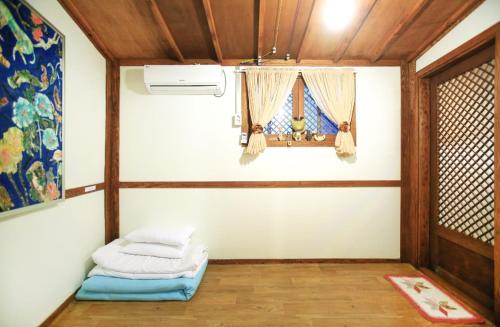 Habitación con cama y ventana en MongYouHwaWon Guesthouse(Painter's house) en Jeonju