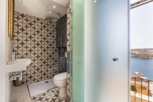 a bathroom with a toilet and a sink at Valletta Harbour View Apartment in Valletta