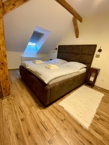a bedroom with a bed with a wooden floor at VILLA ANGEL in Rožňava