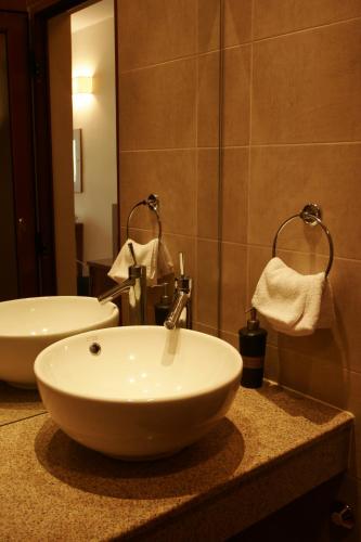 a bathroom with a white sink and a mirror at Villa Valeev in Sozopol