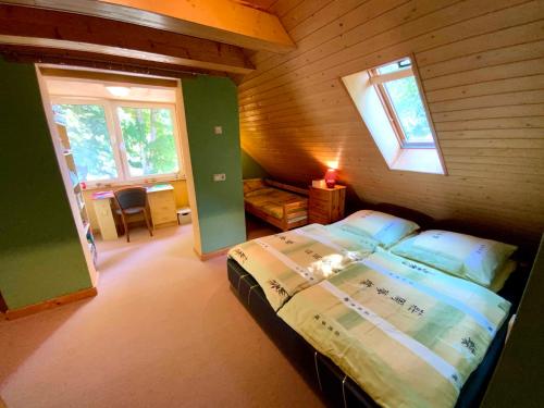 a bedroom with a bed in a wooden cabin at Ferienwohnung Scheffler 