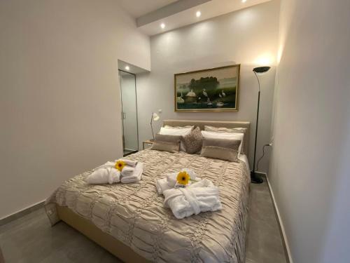 a bedroom with a bed with towels on it at Lemon Suite in Kavala