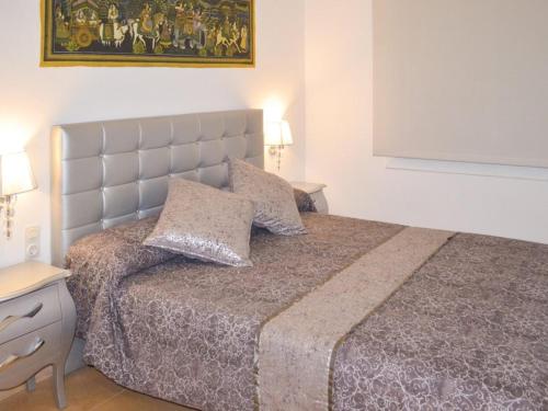 a bedroom with a bed with two pillows on it at Apartament Blue Lloret de mar in Lloret de Mar