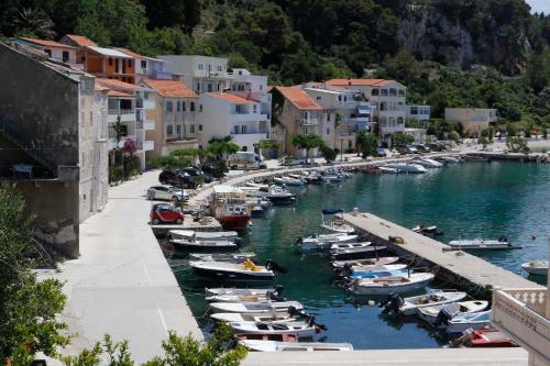 a group of boats are docked in a harbor at Apartmani Rustica in Drasnice