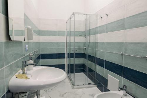a bathroom with a sink and a glass shower at FG Vacanze in Alghero