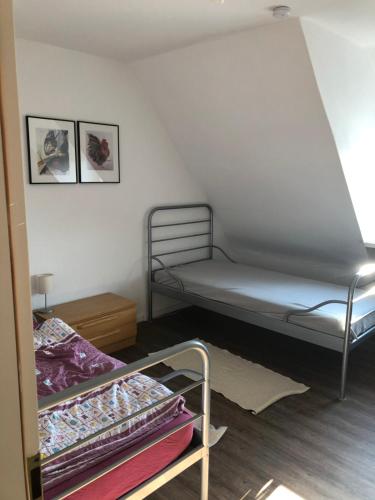 a bedroom with a bunk bed and a bed frame at Gästehaus Cremlingen in Cremlingen