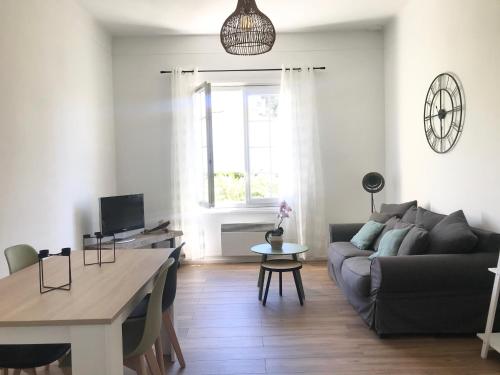 - un salon avec un canapé et une table dans l'établissement Grand F2 quartier Les Plaines, Boulouris proche mer et port Santa-Lucia, à Saint-Raphaël