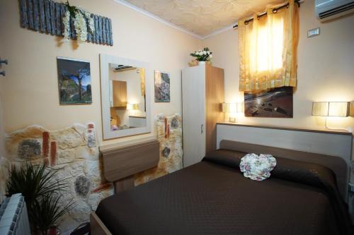 a bedroom with a bed and a mirror in a room at Golden Dreams Reggio Calabria in Reggio di Calabria