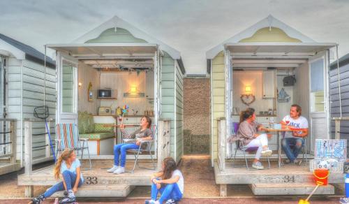 a group of people sitting on the porch of a house at Cumbria Guest House in Lytham St Annes